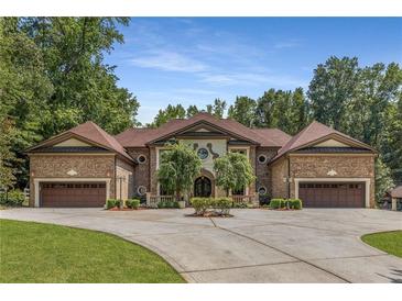 Stately brick home featuring symmetrical design, dual garages, and manicured landscaping at 450 Dorset Sw Way, Smyrna, GA 30082