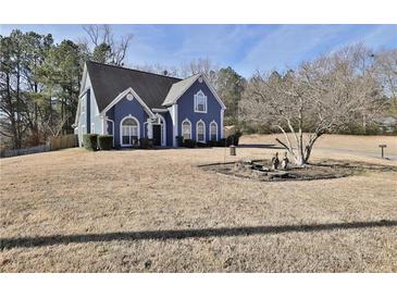 Charming two-story blue home with a well-maintained lawn and attractive landscaping at 5696 Kilrush Se Ct, Mableton, GA 30126