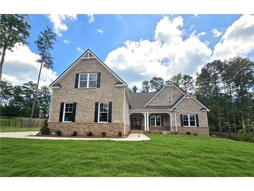 Charming brick home featuring a manicured lawn and classic architectural details at 7791 Capps Ridge Ln, Douglasville, GA 30135