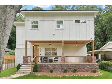 Charming two-story home with a welcoming front porch and beautifully landscaped yard at 1266 Elizabeth Sw Ave, Atlanta, GA 30310