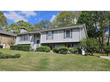 Charming split-level home featuring gray siding, manicured landscaping, and a well-maintained front yard at 4187 Alaina Cir, Austell, GA 30106