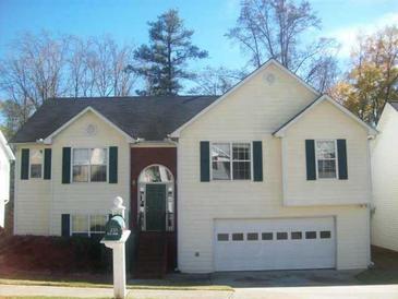 Charming two-story home featuring a front-facing garage and well-maintained yard at 355 Tambec Nw Trce, Lilburn, GA 30047