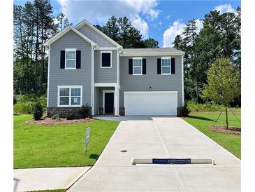 Charming two-story home with a well-manicured lawn and a two car garage at 34 Sonoma Drive, Dallas, GA 30157