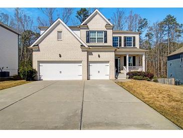 Charming two-story home with a brick facade, two-car garage, and inviting front porch at 2536 Dayview Ln, Atlanta, GA 30331