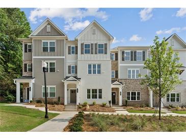 New townhouse exteriors showing a brick and siding facade with manicured lawns at 1995 Deco Dr, Kennesaw, GA 30144