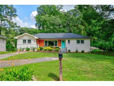 Charming one-story home with colorful door and brick accents on a landscaped lot at 2200 Glendale Dr, Atlanta, GA 30032