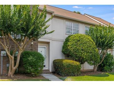 Charming townhouse featuring a well-manicured lawn and mature trees for added curb appeal at 502 Bridge Se Ln, Smyrna, GA 30082