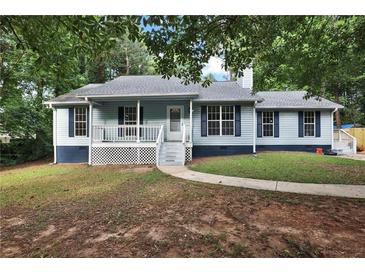 Charming single-story home featuring a cozy front porch and traditional blue siding at 6211 Ward Rd, Union City, GA 30291