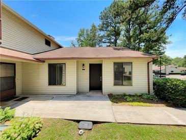 Inviting home exterior featuring a well-maintained lawn and a charming covered front entrance with newer windows at 1152 Country Ct, Lawrenceville, GA 30044
