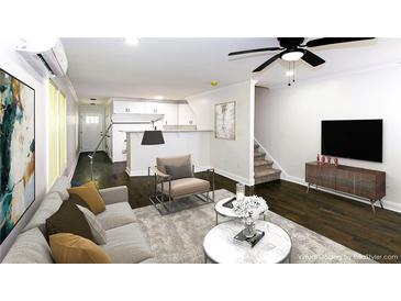 Bright living room featuring an open floor plan, sleek furnishings, and hardwood floors, creating a welcoming atmosphere at 2027 Lois Pl, Atlanta, GA 30318