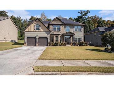 Charming two-story home with a well-maintained lawn and a two-car garage at 6918 Diamond Dr, Rex, GA 30273
