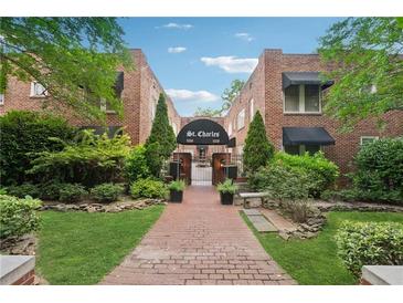 Charming brick apartment building with inviting landscaping and a walkway leading to the entrance at 1026 Saint Charles Ne Ave # 8, Atlanta, GA 30306