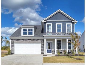 Charming two-story home with stone accents, a two-car garage, and a well-manicured lawn at 522 Regency Trl, Acworth, GA 30102