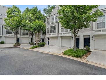 Charming townhome exteriors featuring attached garages and manicured landscaping at 1154 Village Se Ct, Atlanta, GA 30316