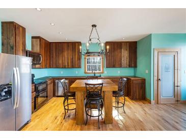 Beautiful kitchen features wood cabinets, a center island with seating, stainless steel appliances and natural light at 3192 Highway 411 Ne, White, GA 30184