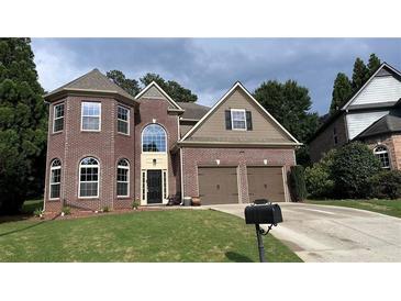 Charming brick home with a well-manicured lawn and two-car garage in a desirable neighborhood at 4990 Arbor View Nw Pkwy, Acworth, GA 30101