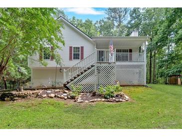 Charming home with a inviting front porch, set amidst lush greenery and a landscaped yard at 1341 Little Deer Run, Canton, GA 30114