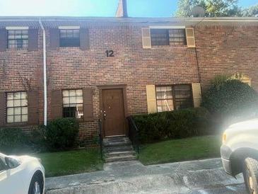 Charming brick townhome with well-maintained landscaping and inviting entrance at 6354 Shannon Pkwy # 12D, Union City, GA 30291