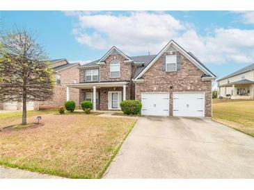 Charming two-story brick home featuring a two-car garage and a welcoming covered front porch at 3019 Iona Ct, Snellville, GA 30039