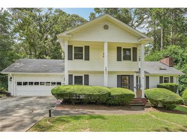 Inviting two-story home featuring a two-car garage, manicured landscaping and a charming front entrance at 1651 King Rd, Riverdale, GA 30296