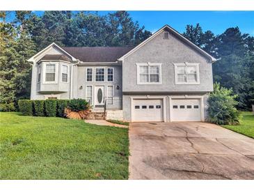 Charming two-story traditional home with a well-manicured lawn and a two-car garage at 11739 Sawgrass Ct, Fayetteville, GA 30215