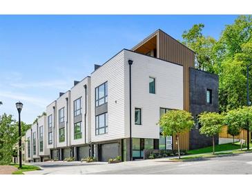 Modern townhome exterior with white siding, black accents, and manicured landscaping offers curb appeal at 1645 Overlook Nw Way # 9, Atlanta, GA 30318
