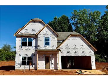 Unfinished two-story home with visible stud framing and a two-car garage awaiting completion at 502 Charleston Pl, Villa Rica, GA 30180