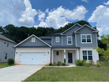 Charming two-story home with a gray roof, white brick, and a two-car garage at 4234 Freight St, Tucker, GA 30084