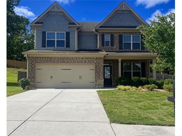 Charming two-story home with a well-manicured lawn and a two-car garage, creating a welcoming curb appeal at 239 Lenore Ct, Hiram, GA 30141