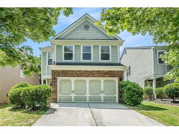 Charming two-story home featuring brick and siding exterior, attached garage, and landscaped yard at 2100 Lily Valley Dr, Lawrenceville, GA 30045