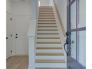 Bright stairway features light wood treads and white risers leading to the upper level at 1915 Deco Dr, Kennesaw, GA 30144