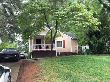 Charming single-Gathering home with a cozy front porch and mature tree at 1566 Avon Sw Ave, Atlanta, GA 30311