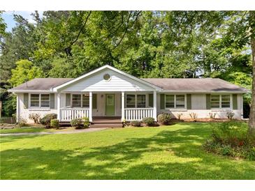 Charming single-story home with a well-manicured lawn and inviting front porch at 3999 Phils Ct, Tucker, GA 30084