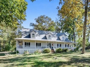 Charming home with a large, inviting wraparound porch and well-manicured front lawn at 3530 Dahlonega Hwy, Cumming, GA 30028