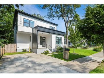 Modern two-story home with a concrete driveway and a well-manicured lawn at 833 Humphries Sw St, Atlanta, GA 30310