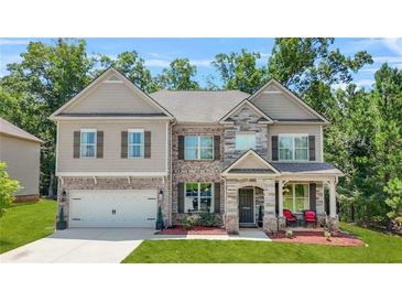 Charming two-story home with a brick and stone facade and well-manicured lawn at 625 St Annes Pl, Covington, GA 30016