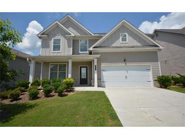 Charming two-story home with a manicured lawn, a two-car garage and covered front porch at 2504 Bear Mountain St, Lithonia, GA 30058