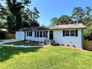 Charming, updated single-story home with a well-manicured front lawn at 6751 Davidson Ct, Lithonia, GA 30058