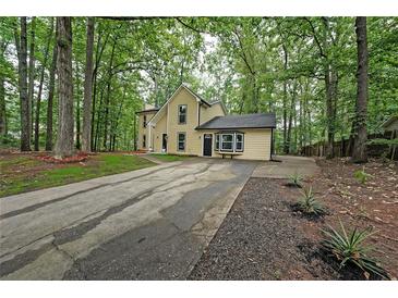 Charming two-story home with a long driveway and large mature trees at 7156 Whitfield Drive Dr, Riverdale, GA 30296