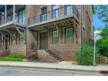 Beautiful brick townhouse featuring a charming covered entrance and elegant iron railings at 504 E Howard Ave, Decatur, GA 30030