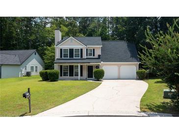 Charming two-story home featuring a well-manicured lawn and a two-car garage at 2161 Denson Sw Ln, Marietta, GA 30008