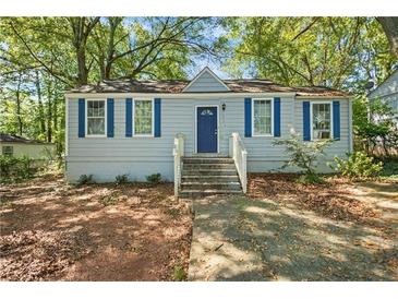 Charming single-story home featuring blue shutters and a well-maintained front yard at 1324 Almont Sw Dr, Atlanta, GA 30310