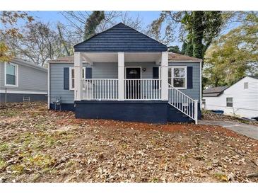 Charming blue home with a covered front porch and freshly painted blue trim at 1417 Graymont Sw Dr, Atlanta, GA 30310
