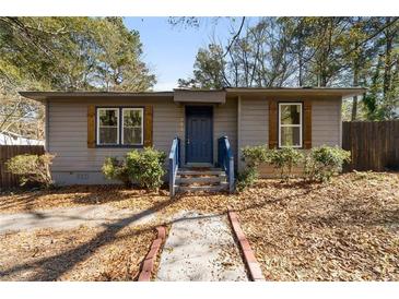Charming single-story home with gray siding, blue door, and well-maintained landscaping at 501 Aberdeen Nw Dr, Atlanta, GA 30318