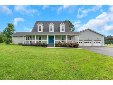 Charming home featuring a large porch, well-manicured lawn, and a three-car garage at 500 Coleman Mill Rd, Carrollton, GA 30116