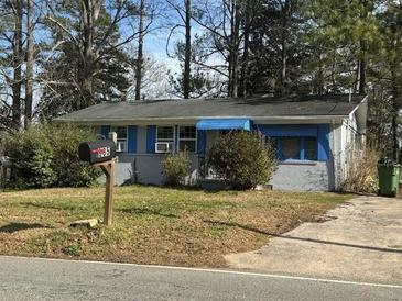 Charming single-story home featuring a brick facade, blue trim, and a well-maintained lawn at 685 Bolton Nw Rd, Atlanta, GA 30331