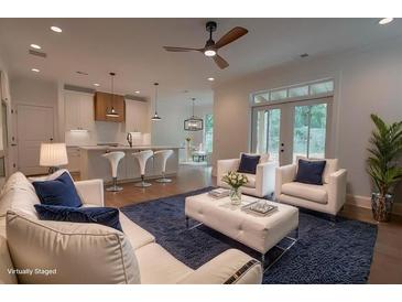 Bright, open-concept living area with modern finishes, connecting seamlessly to the kitchen and dining space at 3007 Holly St, Canton, GA 30115