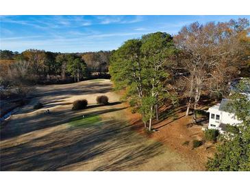 Scenic golf course view backing up to a well-maintained home in a lush, wooded area at 138 Elysian Nw Way, Atlanta, GA 30327