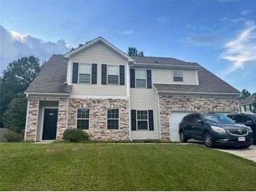 Charming two-story home with stone accents, dark shutters, and a well-manicured lawn at 20 Monarch Way, Hiram, GA 30141