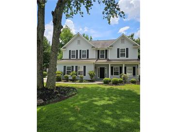 Charming two-story home with manicured lawn, black shutters, and inviting front porch at 4845 Weathervane Dr, Alpharetta, GA 30022